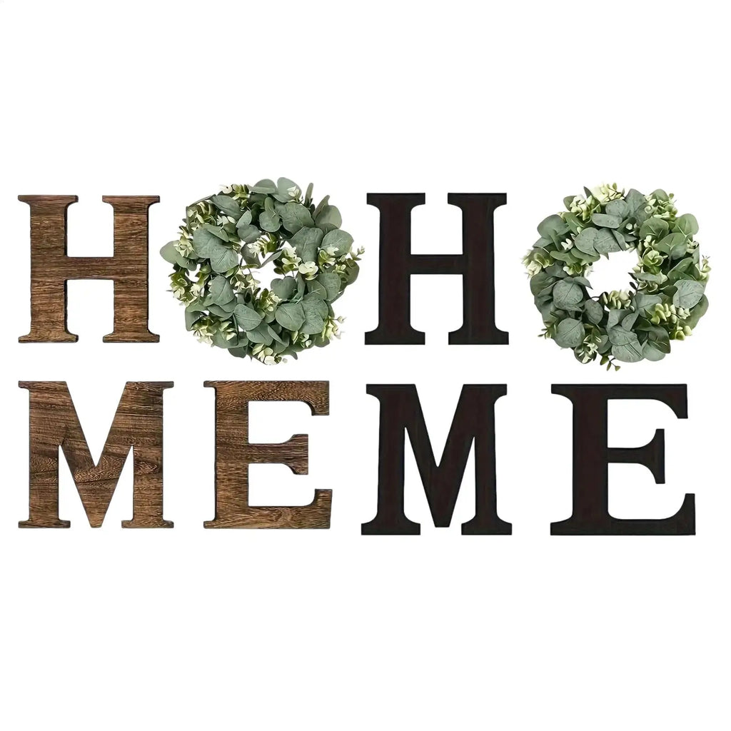 Rustic wooden wall letters spelling "HOME", with two artificial eucalyptus wreaths replacing the 'O's.
