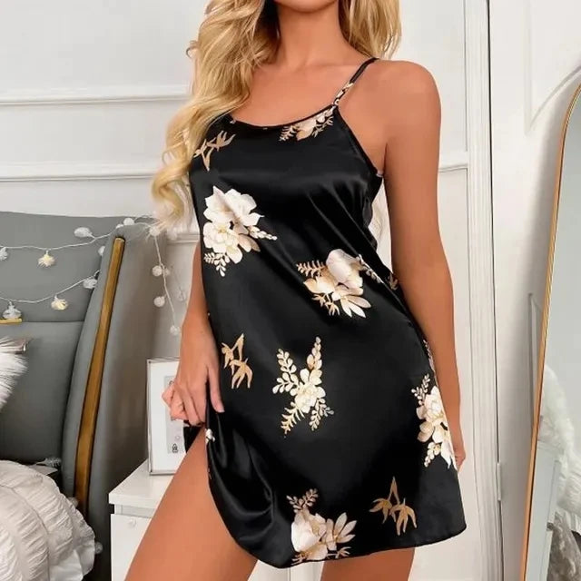 Black satin camisole nightdress with a white and gold floral print, featuring adjustable spaghetti straps.