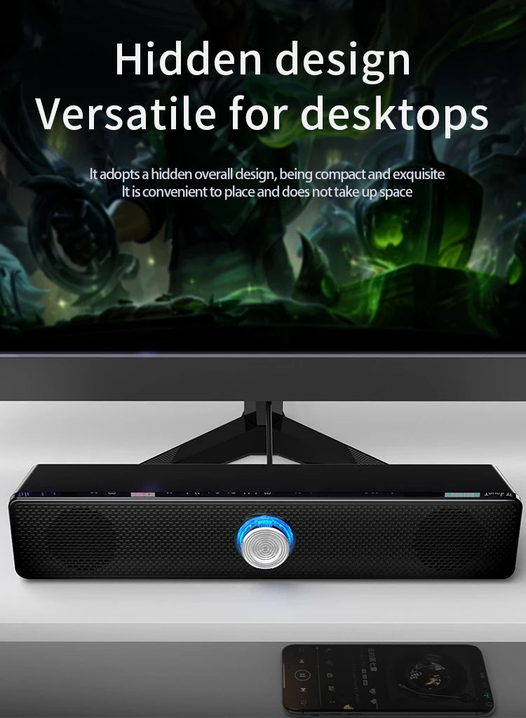 Compact black USB stereo soundbar for desktops, featuring a central illuminated volume control knob.