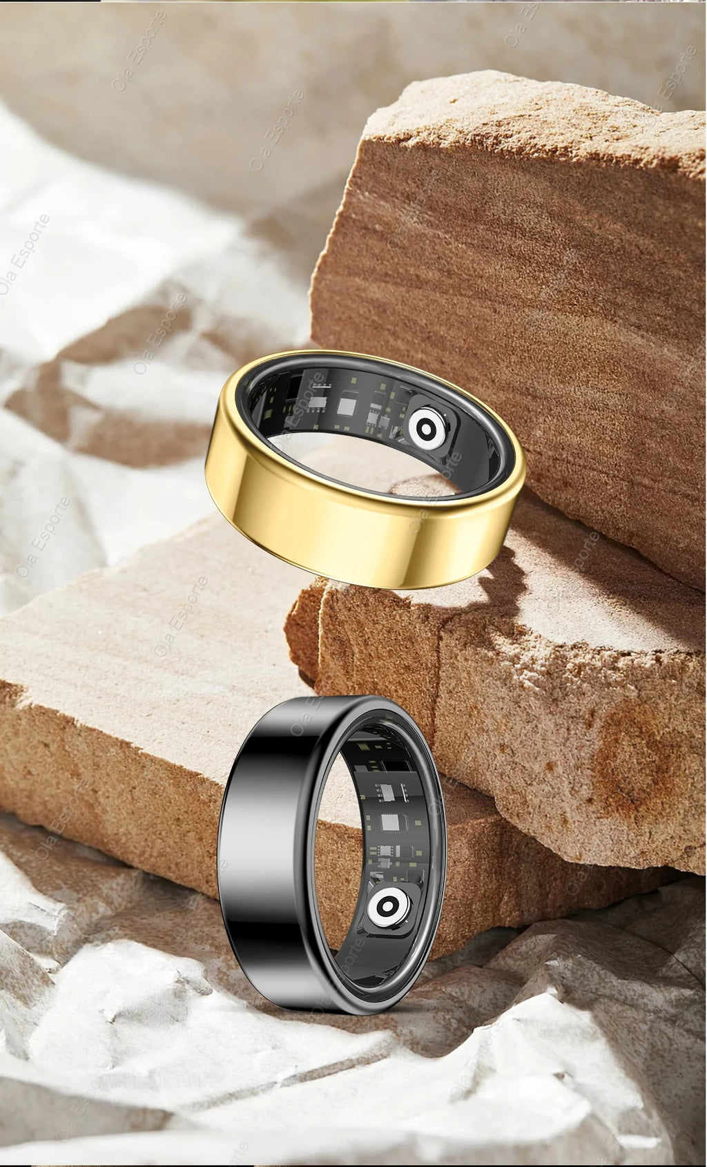Gold and black smart rings with visible internal health tracking sensors, displayed on textured stone surfaces.