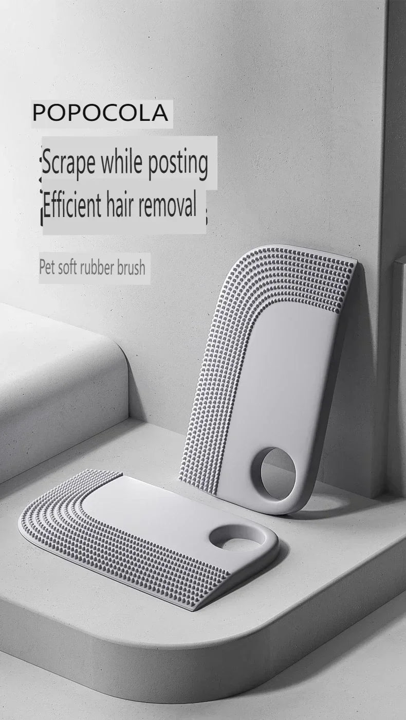 Two grey, soft rubber pet hair removal brushes with textured edges and a circular hole for hanging.