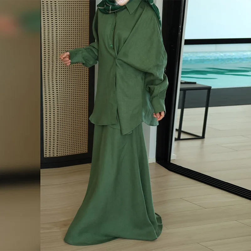 Sage green two-piece modest set featuring a button-down shirt with balloon sleeves and a matching floor-length skirt.