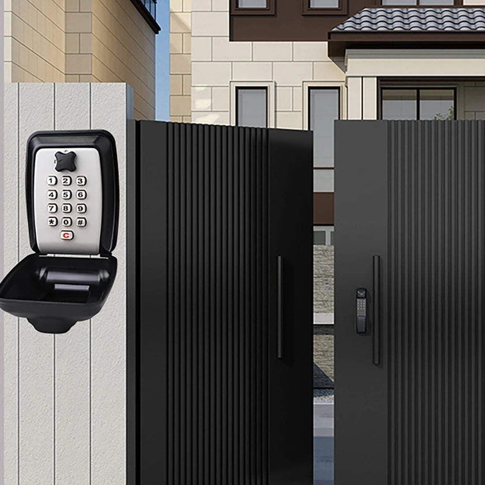 Black metal wall-mounted key lock box with a silver push-button keypad and protective cover.