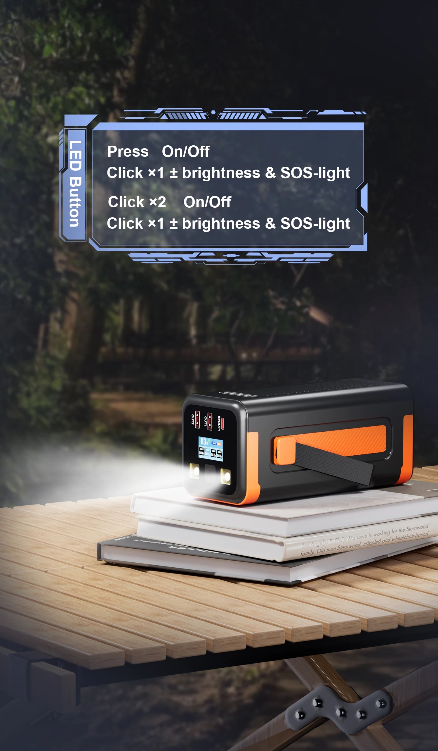 Black and orange 50000mAh portable power bank with a built-in LED flashlight and digital display, sitting on a table.