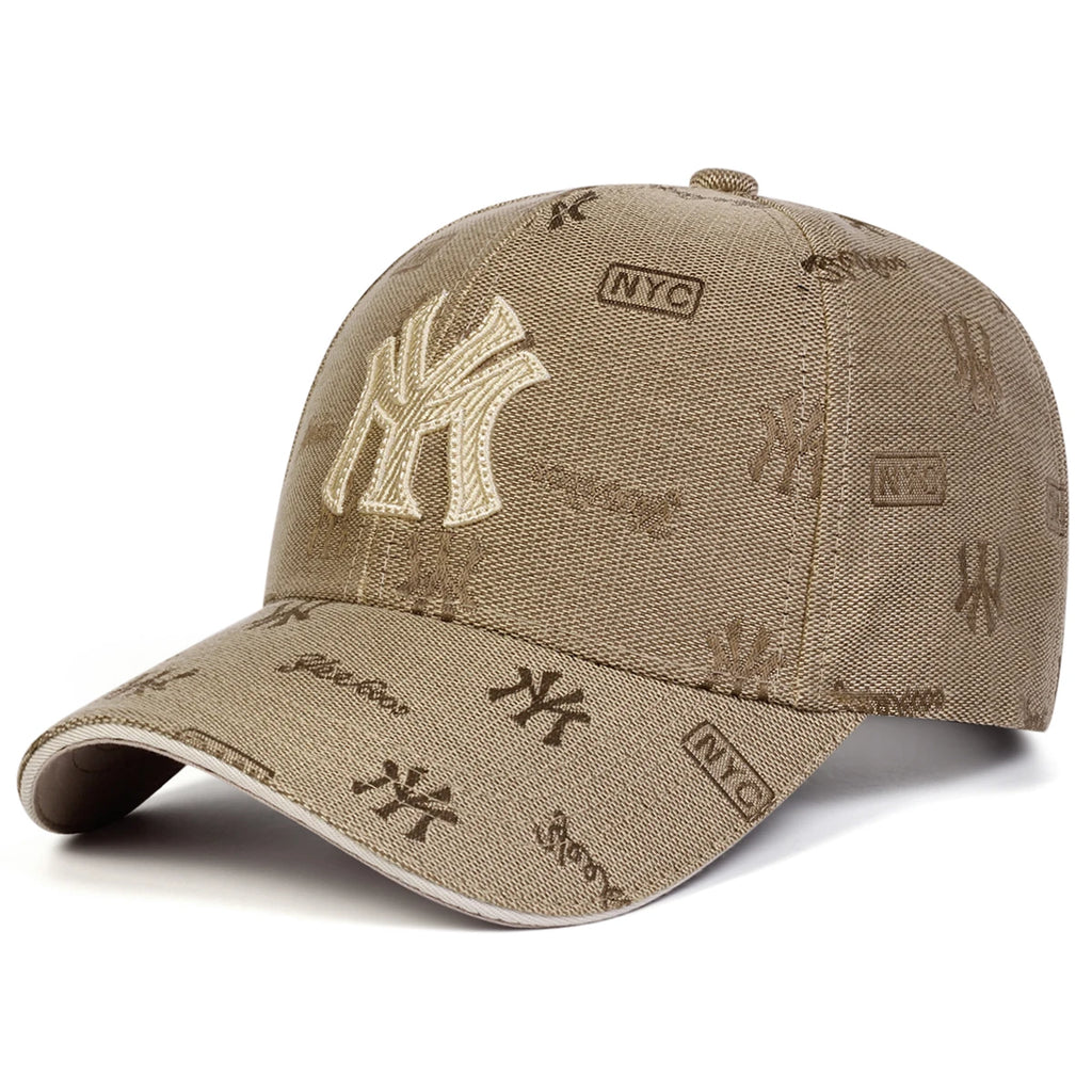 Beige unisex baseball cap with an all-over monogram print and large embroidered 'MY' lettering on the front.