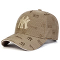 Beige unisex baseball cap with an all-over monogram print and large embroidered 'MY' lettering on the front.