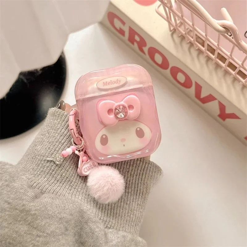 Pink translucent My Melody AirPods case with a bow charm and fluffy pom-pom keyring.