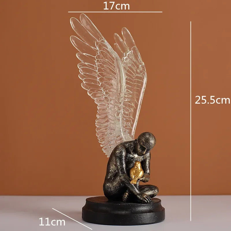 Decorative bronze-finish angel statue with clear resin wings, holding a gold bird, on a circular black base.