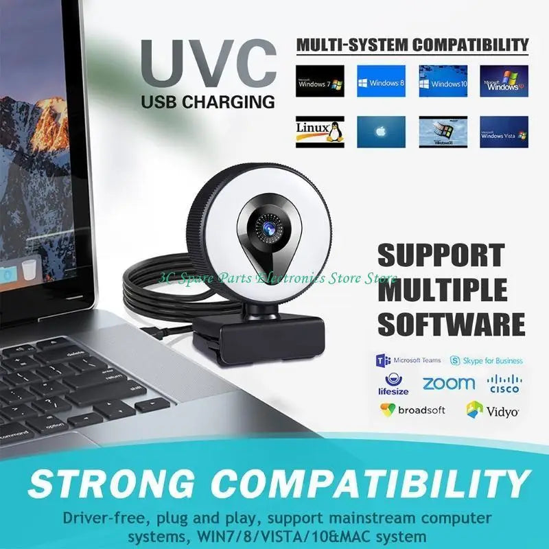 Black USB webcam with an integrated circular ring light, mounted on a clip stand, sitting next to a laptop.
