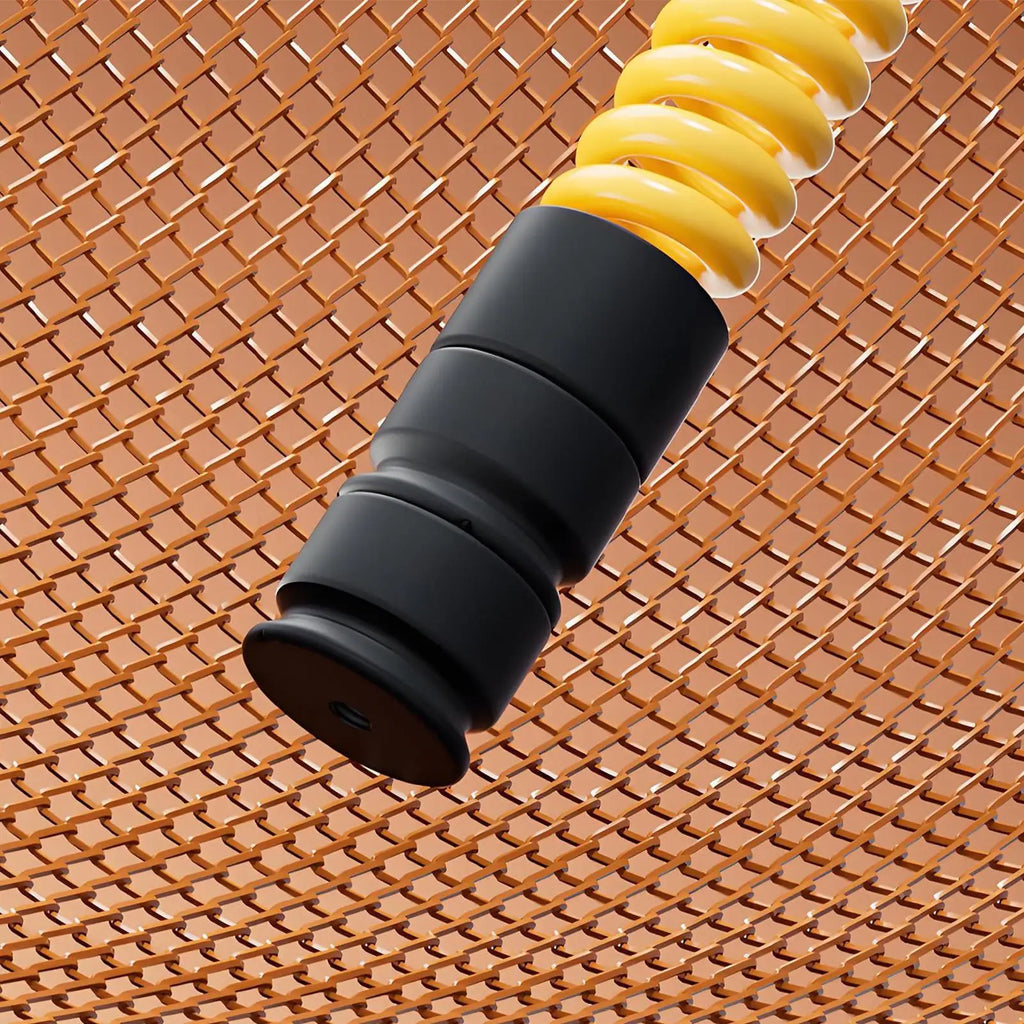 Bright yellow coiled fitness training rope with a smooth black ergonomic handle against a copper mesh background.