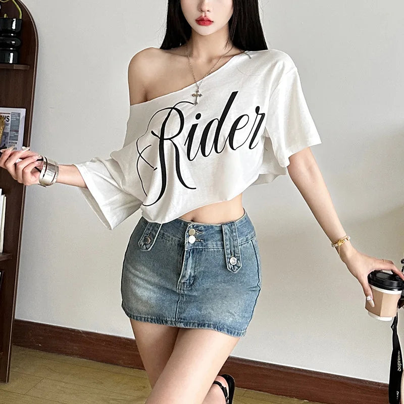White oversized off-shoulder crop t-shirt with black "Rider" letter print and short sleeves.