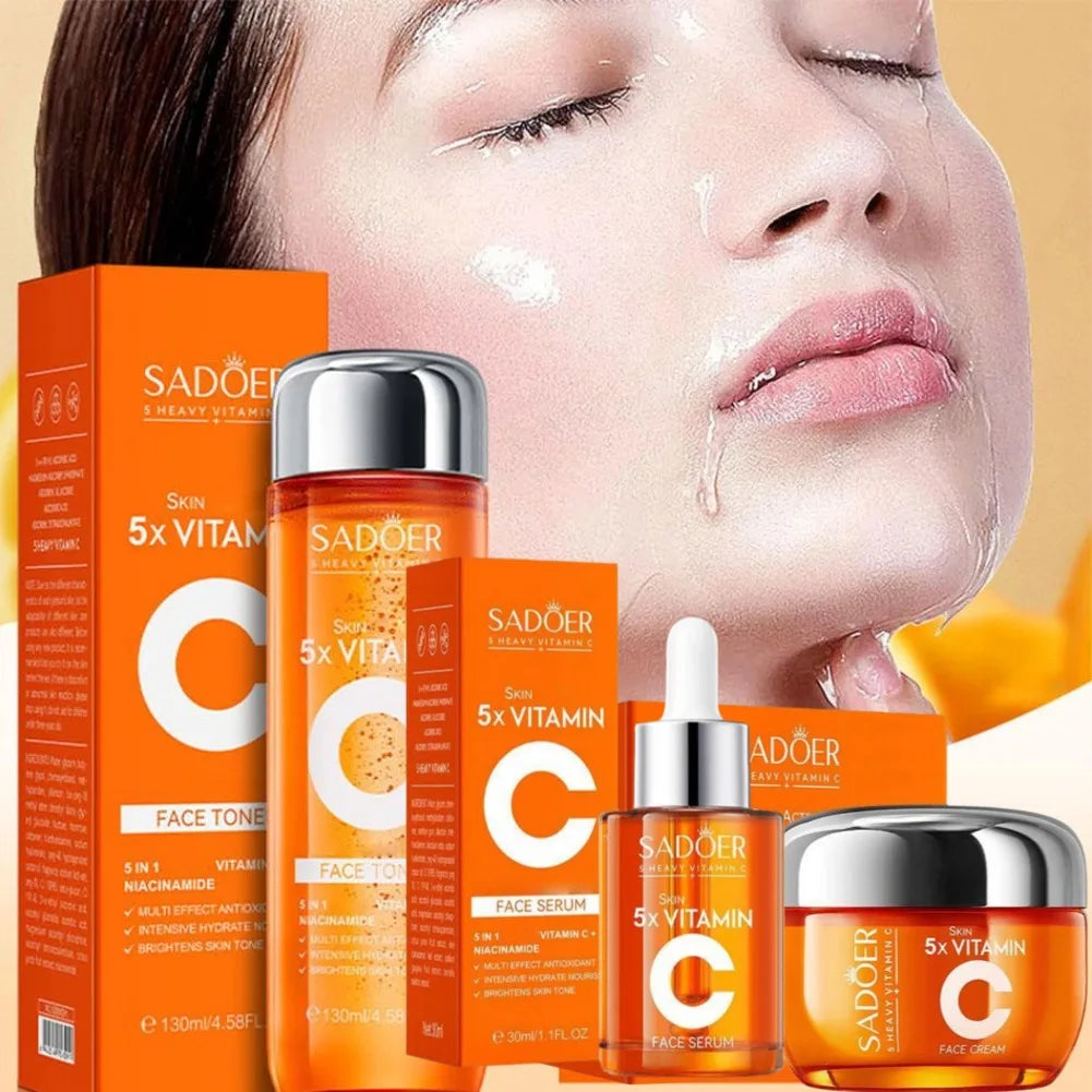 Set of orange Vitamin C skincare products, including face toner, serum, and cream, against a model with glowing skin.