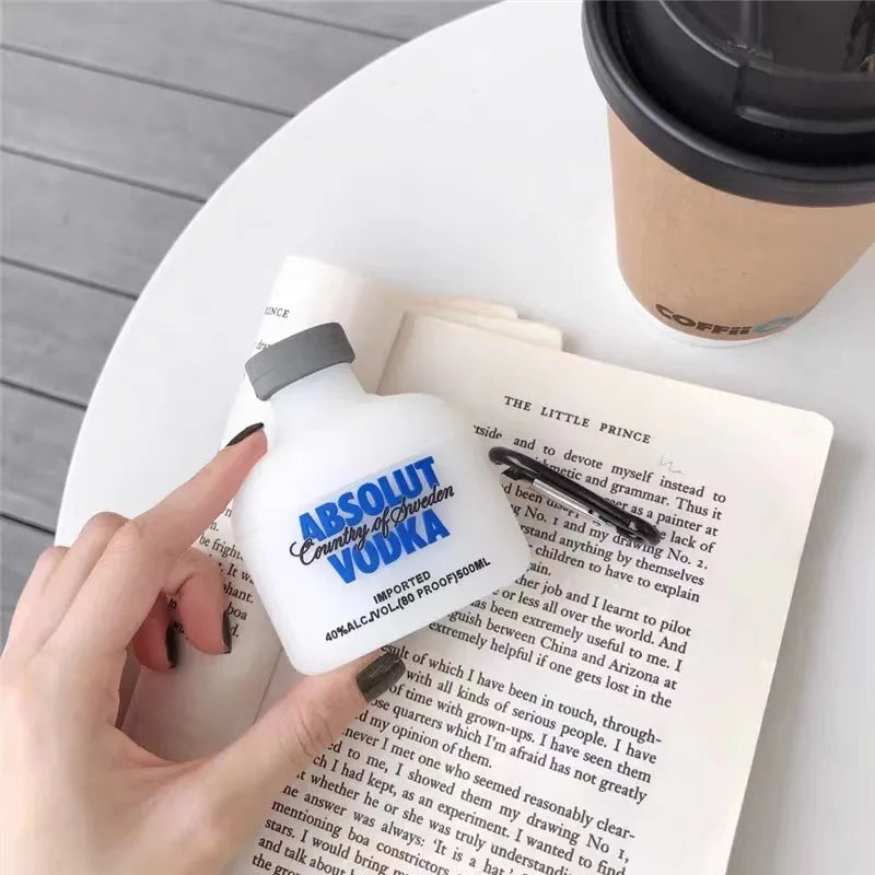 White silicone AirPods case shaped like an Absolut Vodka bottle with a grey cap. Fits standard AirPods charging cases.