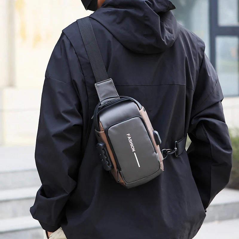 Grey anti-theft crossbody chest bag with USB charging port and combination lock, worn over a black jacket.
