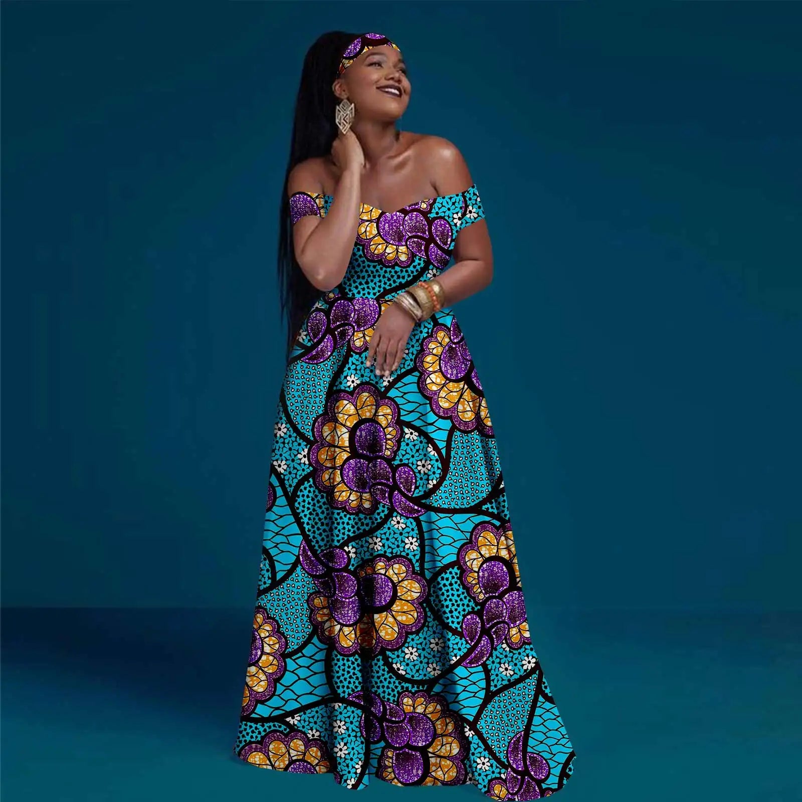 Off-the-shoulder maxi dress in turquoise, purple, and gold floral print with matching headband on a smiling woman.