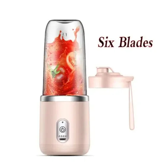 Portable pink personal blender with six blades and a clear cup containing tomato juice, plus a matching lid.