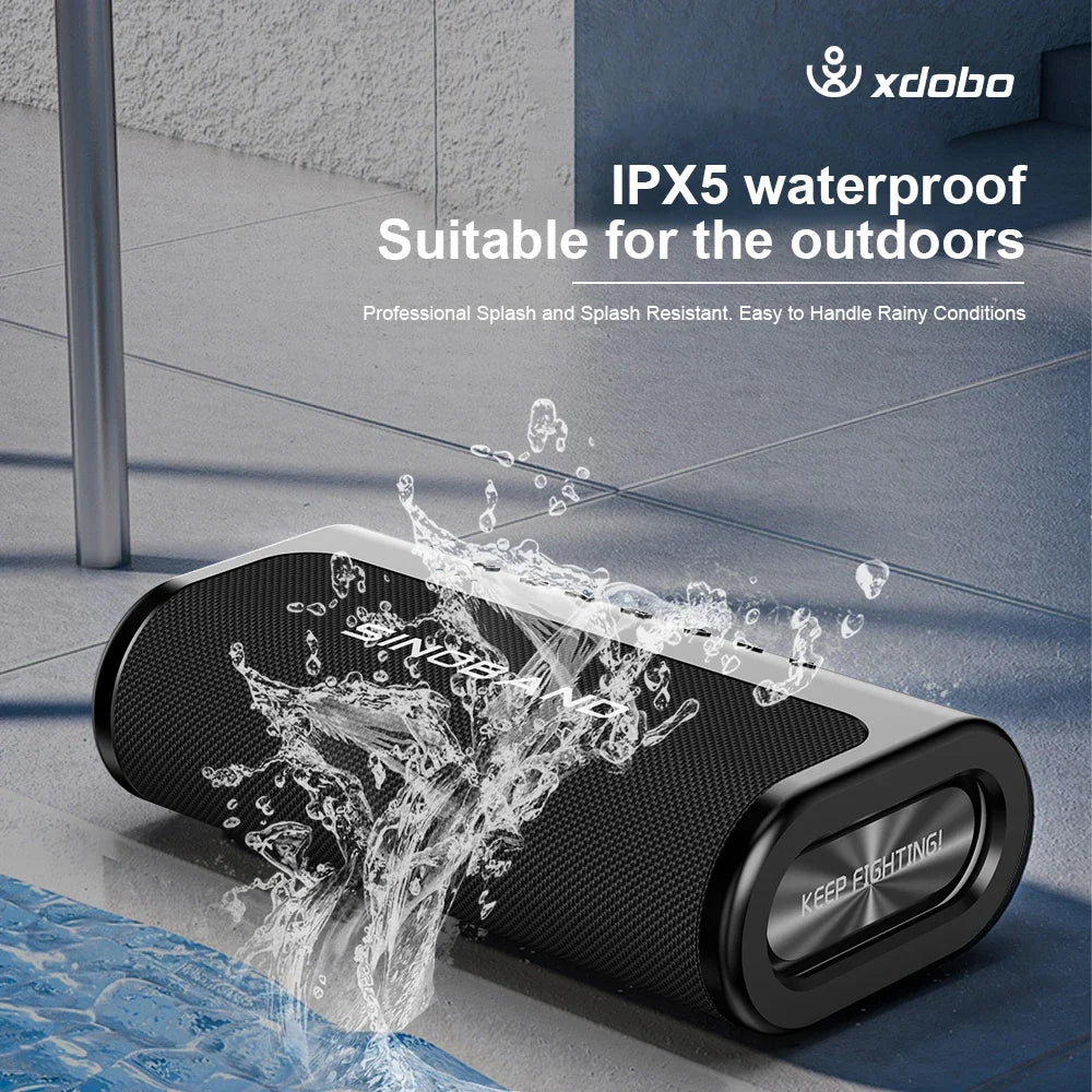 Black, rectangular 80W wireless speaker with a mesh finish and splash-resistant design, positioned near water.