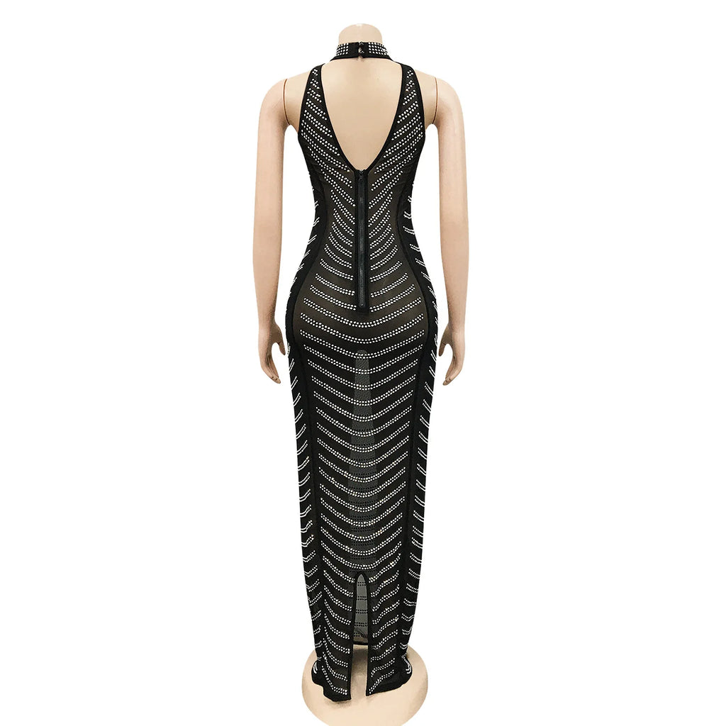 Backless black maxi dress on mannequin, featuring sheer mesh fabric and sparkling gold beaded stripes.