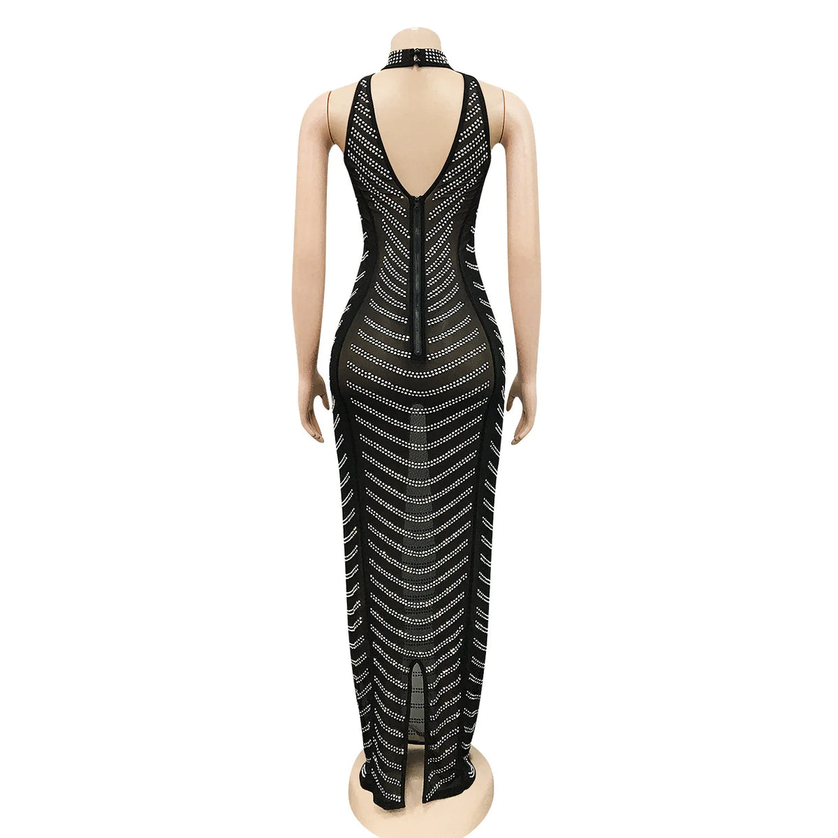 Backless black maxi dress on mannequin, featuring sheer mesh fabric and sparkling gold beaded stripes.