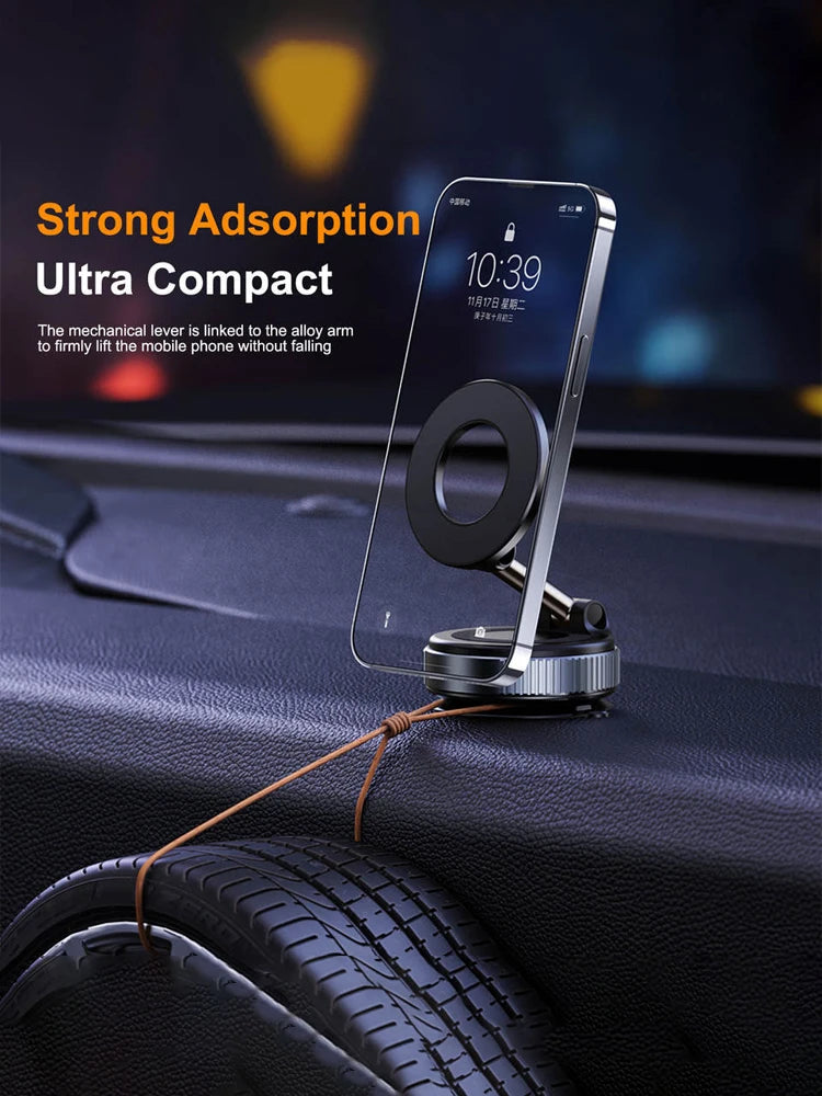 Compact, silver alloy magnetic phone car mount holding a smartphone on a textured dashboard.