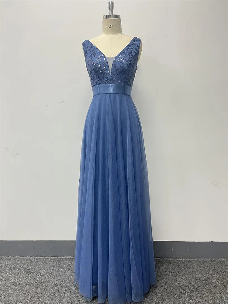 Dusty blue evening maxi dress with a V-neck, sequined sleeveless bodice, satin waistband, and flowing tulle skirt.