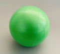 A bright green, textured yoga or Pilates exercise ball isolated against a neutral grey background.