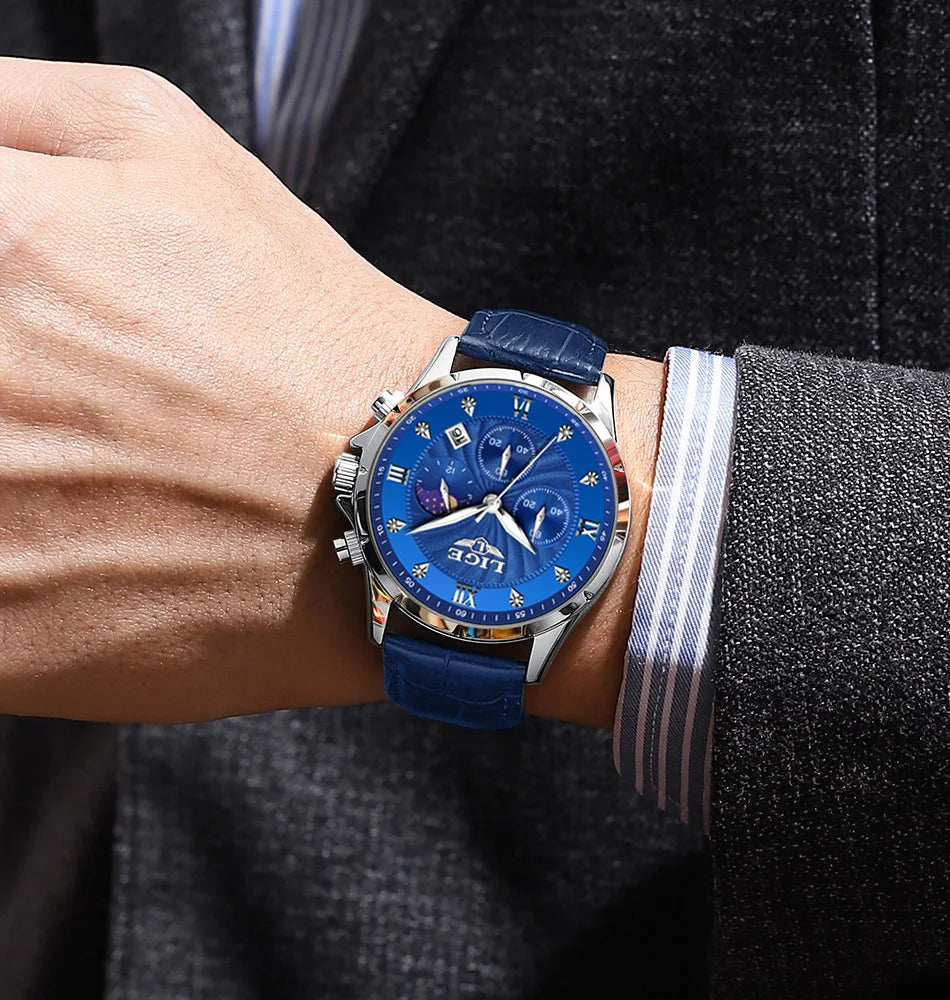 Men's classic blue chronograph watch with a textured leather strap, silver casing, and sunburst blue dial.