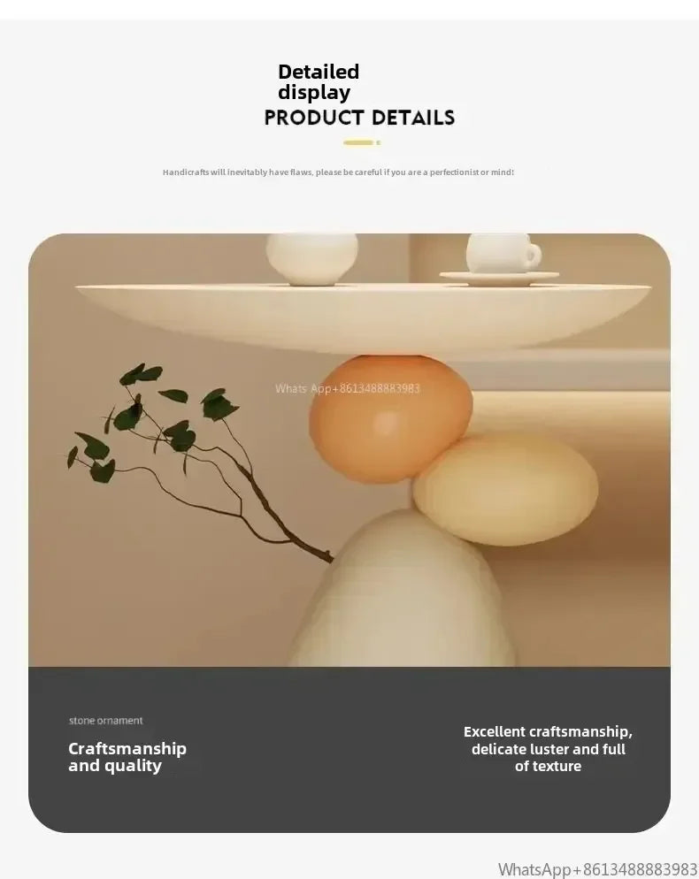 Minimalist cream-coloured side table featuring a smooth, sculptural base of stacked stone-effect spheres.