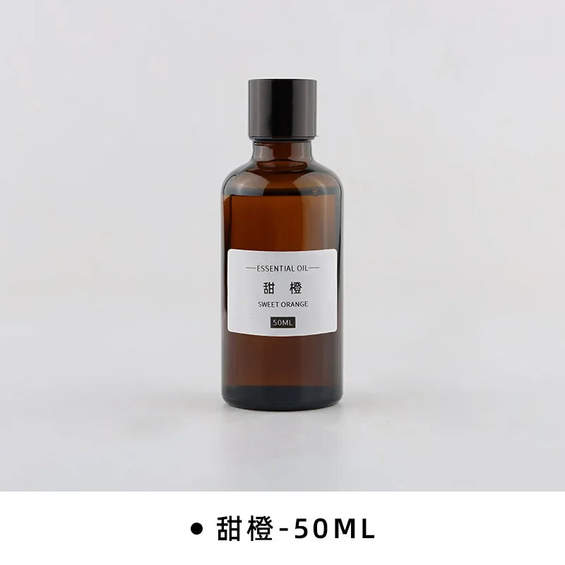50ml amber glass bottle of sweet orange essential oil with a black screw cap and minimalist white label.