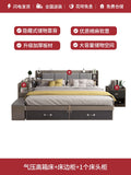 Modern grey upholstered bed with integrated shelving, storage headboard, under-bed drawers, and matching bedside table.