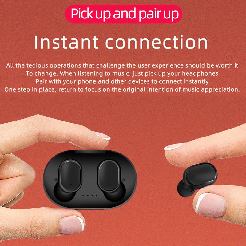 Small black matte wireless earbuds and their oval charging case held by fingers against a coral-orange background.