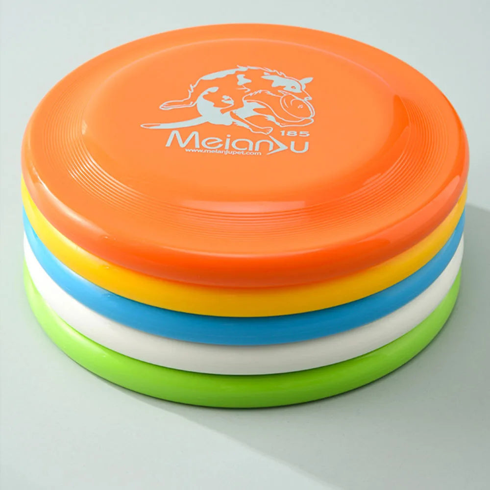 A stack of five colourful, durable dog flying discs in orange, yellow, blue, white, and lime green.