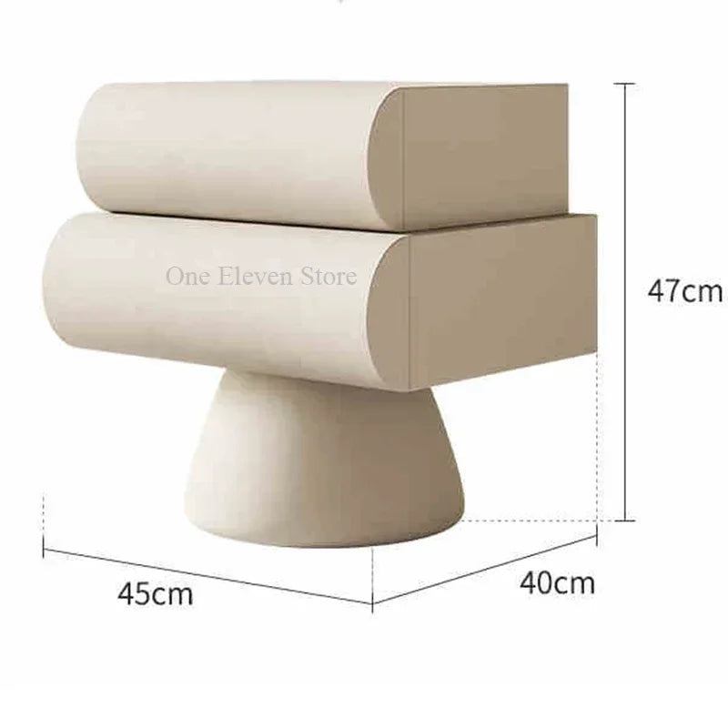 Modern cream bedside table with two drawers, featuring a unique curved design on a sturdy pedestal base.