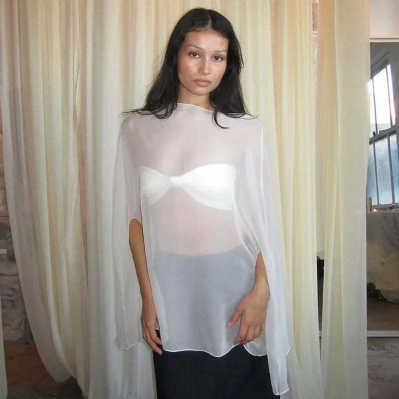Sheer white chiffon cape-style top with a loose fit, worn over a white bandeau top.