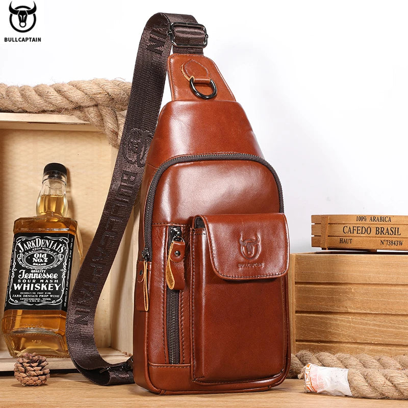 Tan leather crossbody sling bag with adjustable brown strap, multiple zip compartments and a front flap pocket.