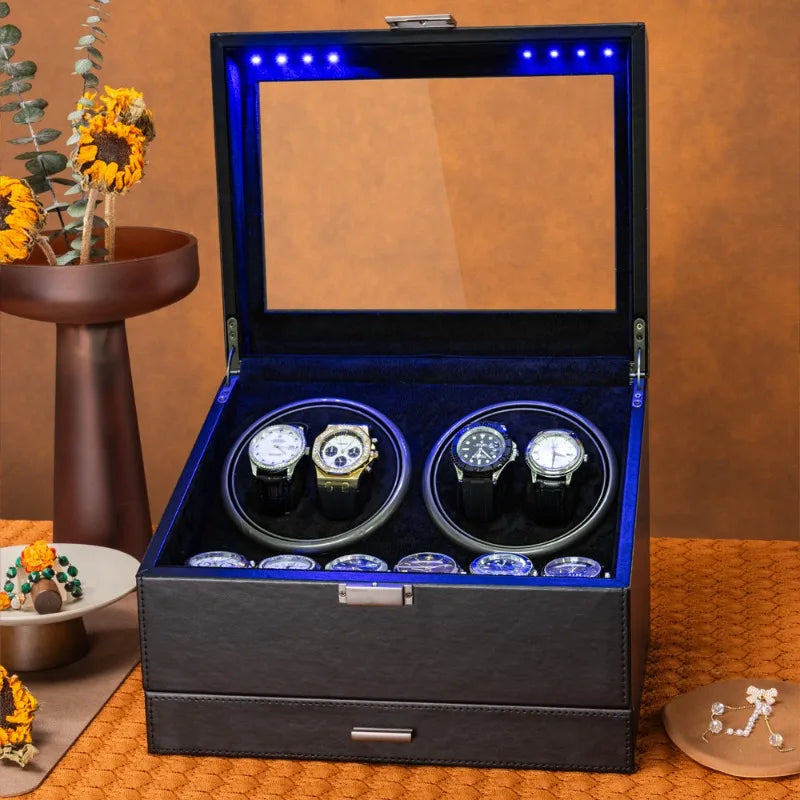Black leather watch winder box with glass lid, blue interior lighting, dual winders, and lower storage drawer.