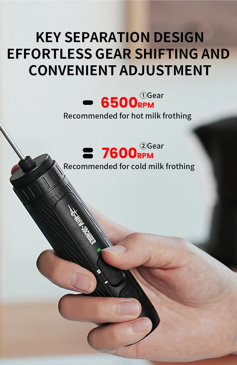 A black, handheld electric milk frother with two adjustable speed settings for hot and cold frothing.