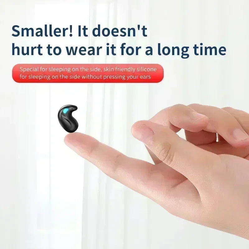 Small, black, ergonomic silicone earbud for sleeping balanced on a fingertip.