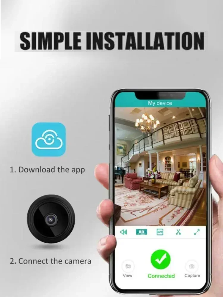 Hand holding a smartphone showing a living room camera feed, next to a small black circular plastic security camera.