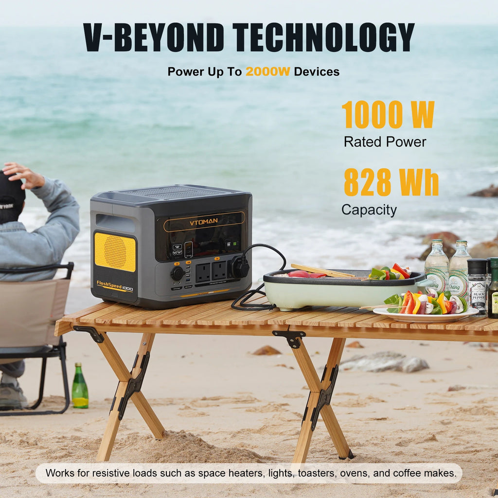 A portable power station sits on a wooden table at the beach, powering an electric grill.