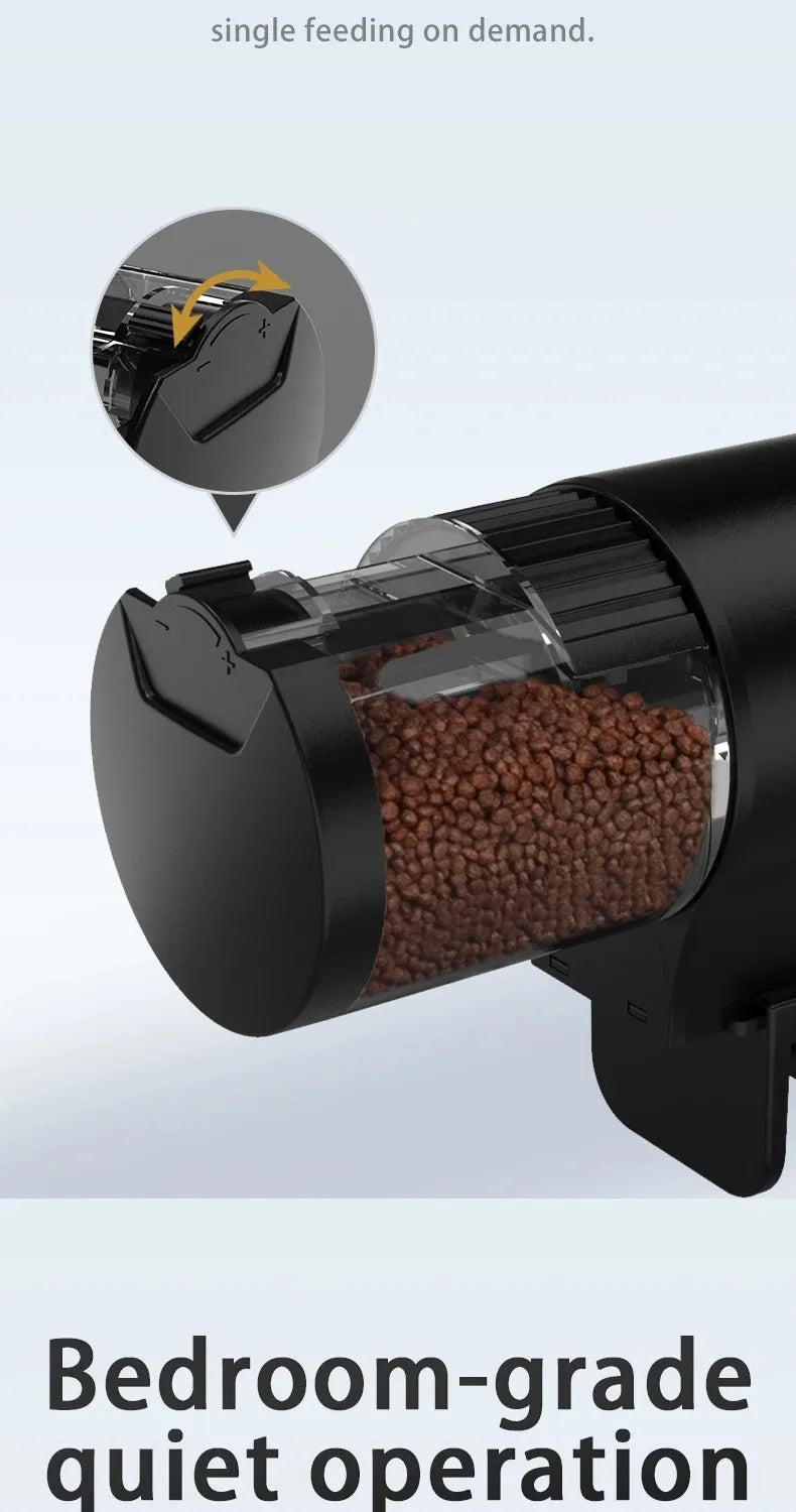 Black automatic pet food dispenser with a clear container showing dry kibble and a rotating feeding mechanism.
