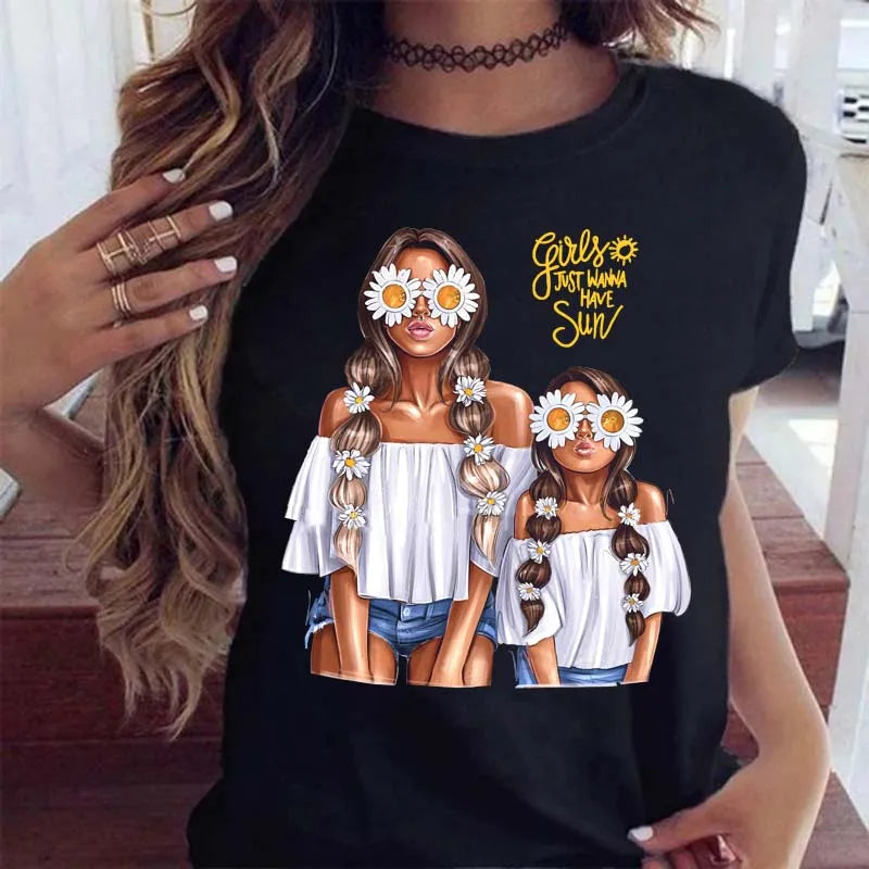 Black t-shirt featuring an illustration of two girls with daisy sunglasses and hair clips, with "Girls Just Wanna Have Sun."