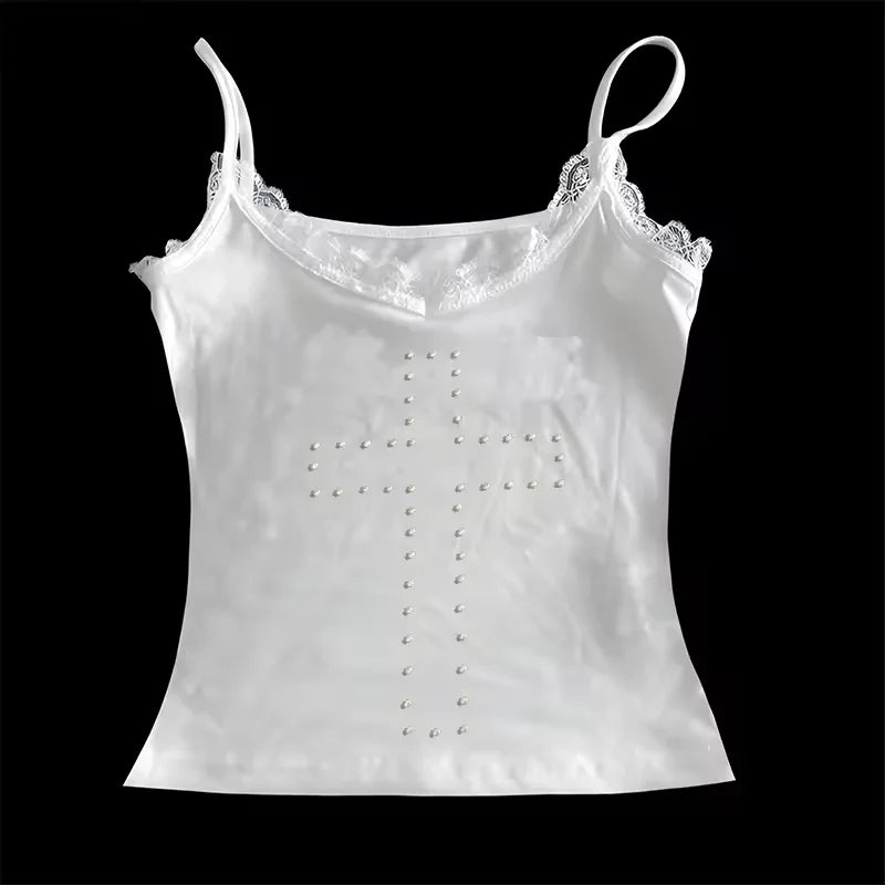White satin camisole top with thin straps, lace neckline trim, and a decorative studded cross design on the front.