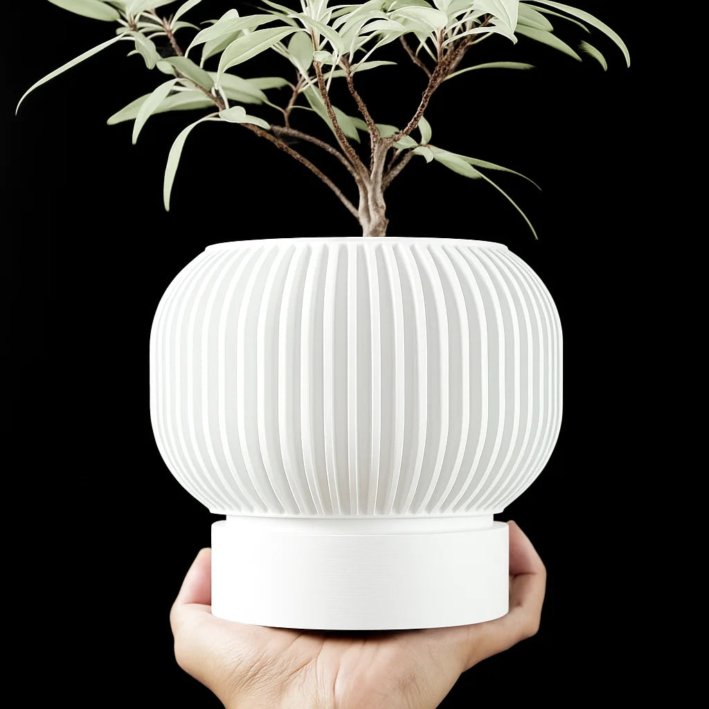 A hand holds a white, 3D-printed plant pot with vertical ribbed textures and a smooth base against a black background.