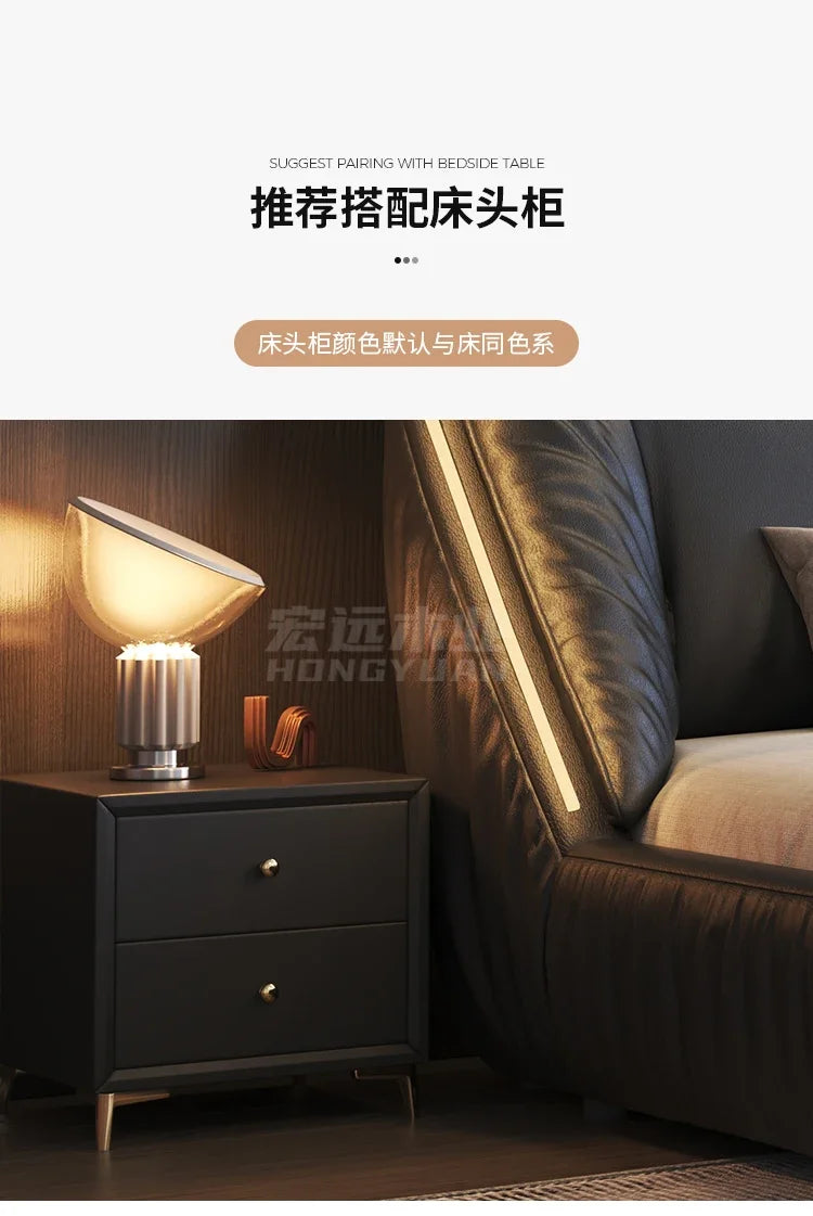 Modern black upholstered king-size bed frame featuring a sleek, curved headboard with integrated vertical LED lighting.