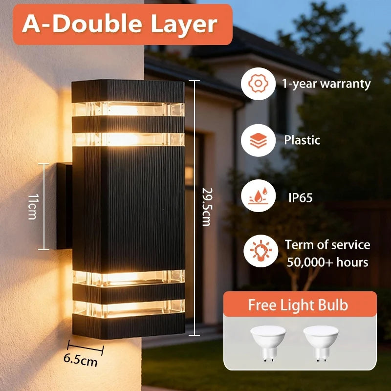 Modern black rectangular outdoor wall light with double-layer warm LED glow, mounted on a white exterior wall.