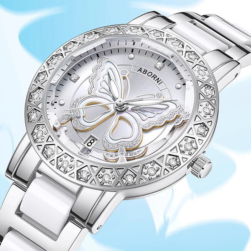 Luxury women's silver and white watch featuring a crystal-embellished bezel and a decorative butterfly dial.