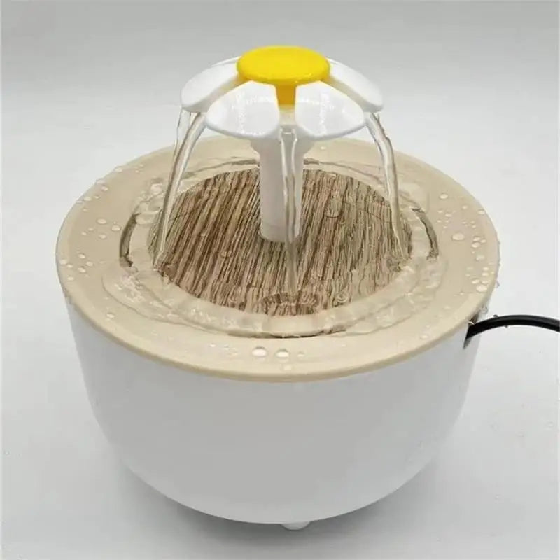 White and beige pet water fountain featuring a yellow and white daisy-shaped top with cascading water.