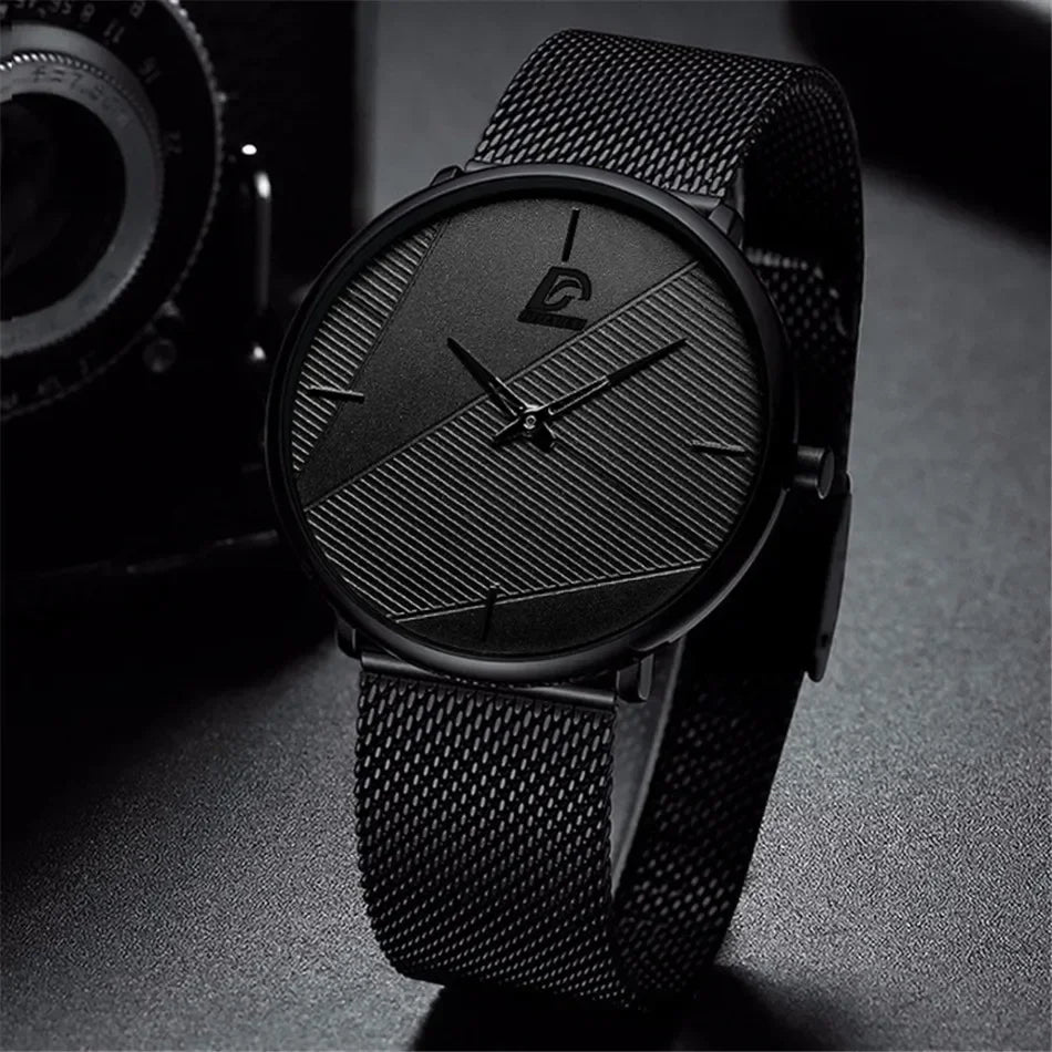 Minimalist men's ultra-thin quartz watch in matte black with a textured dial and mesh strap.