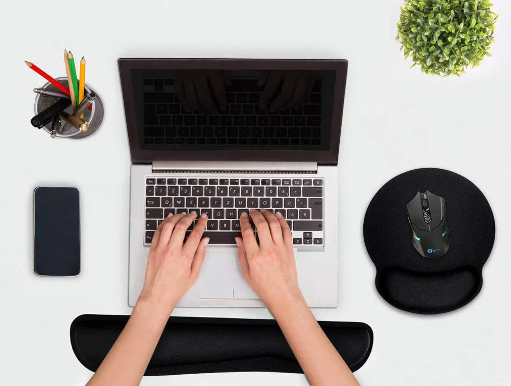 Overhead view of a black foam mouse pad with a built-in wrist rest and a black ergonomic gaming mouse.